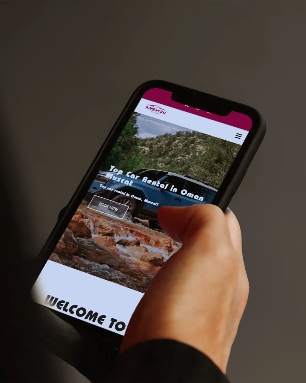 Miskin Car Rental website on a phone